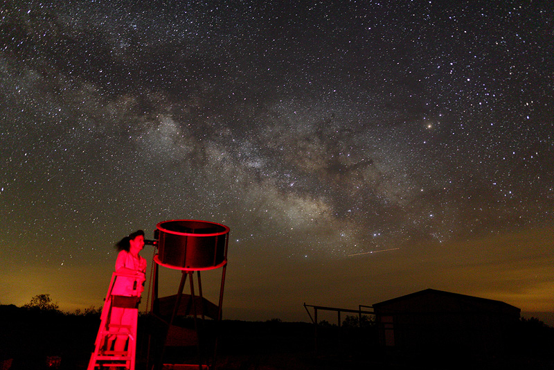 Christina observes with the summer Milky Way behind