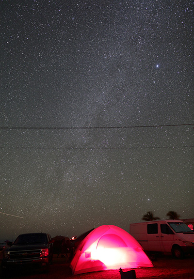 Southern Milky Way over a glowing tent