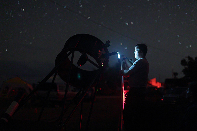 Mike Lockwood is illuminated by a borrowed cell phone image of M42, and the image is seen above