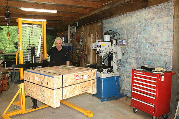 Peter brings the crate into his shop