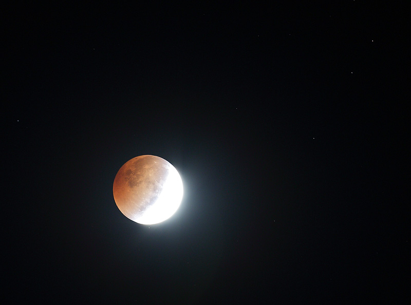 Eclipsed moon through harvest dust